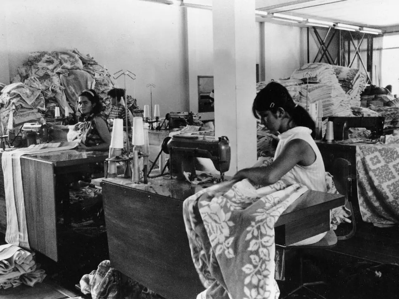 In the image we can see there are people sitting on the chair and there is sewing machine kept on...