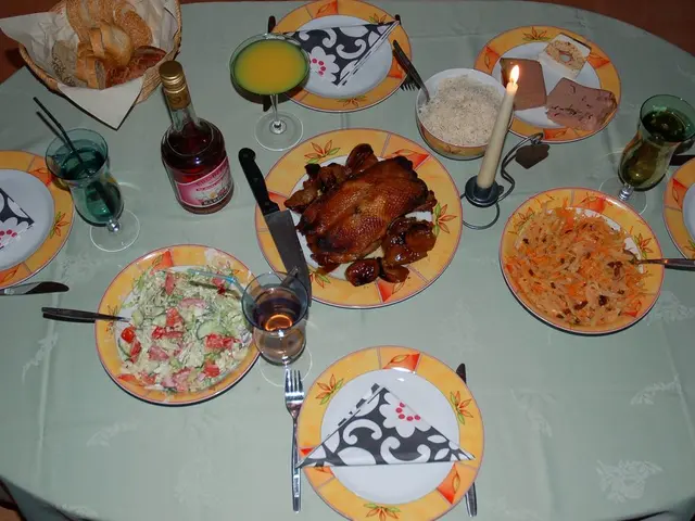 In this picture there is a table, on the table there are plates, glasses, a bottle, bowl, basket,...