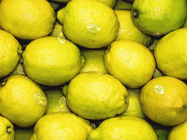 In this image, we can see lemons with stickers.